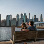 couple sur un banc regardant la skyline de manhattan
